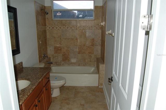 full bathroom with vanity, tiled shower / bath, and toilet