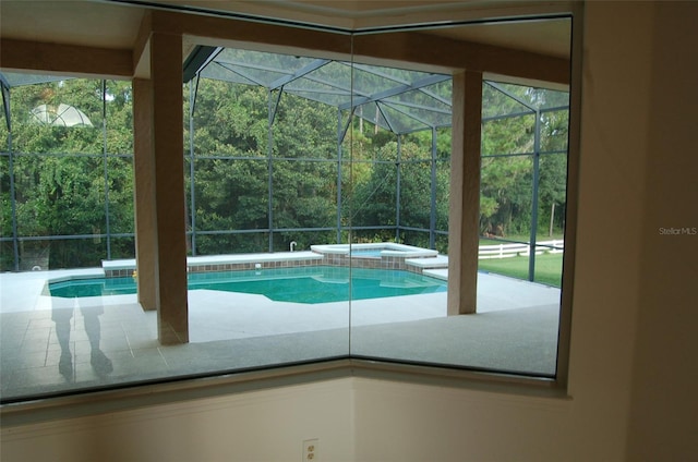 view of pool featuring an in ground hot tub, a patio, and glass enclosure