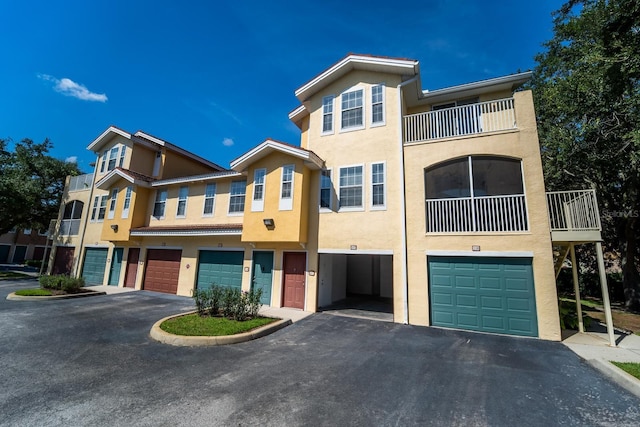 view of front of home featuring a balcony and a garage