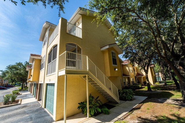 view of property featuring stairway and an attached garage