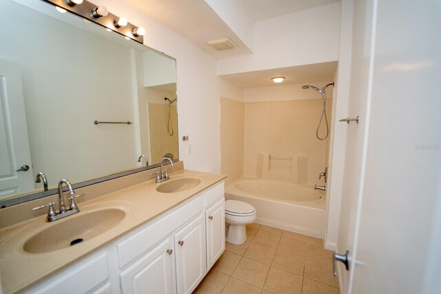 full bathroom featuring tiled shower / bath combo, toilet, tile patterned floors, and dual bowl vanity