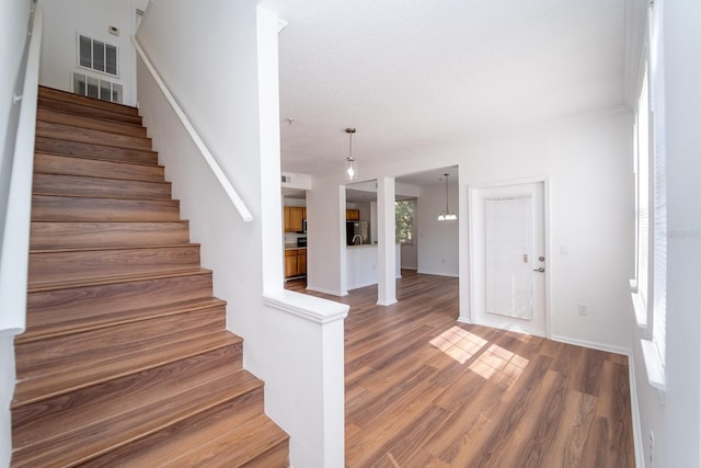 stairs with hardwood / wood-style floors