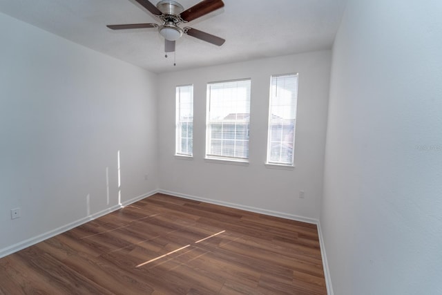 spare room with ceiling fan and dark hardwood / wood-style flooring