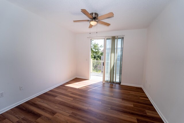 spare room featuring ceiling fan and dark hardwood / wood-style floors