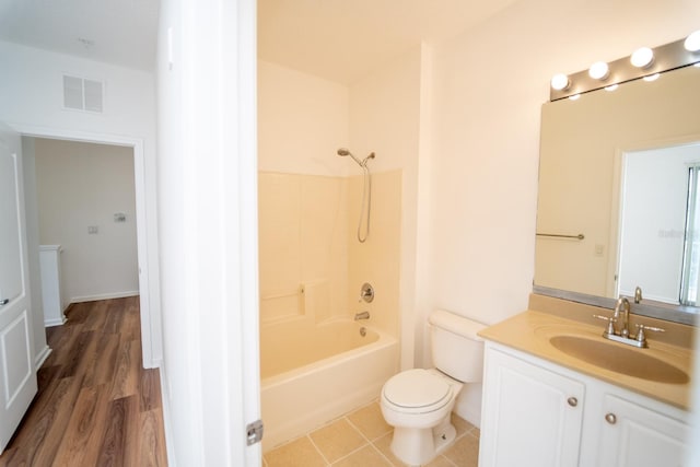 full bathroom featuring shower / bathtub combination, vanity, wood-type flooring, and toilet