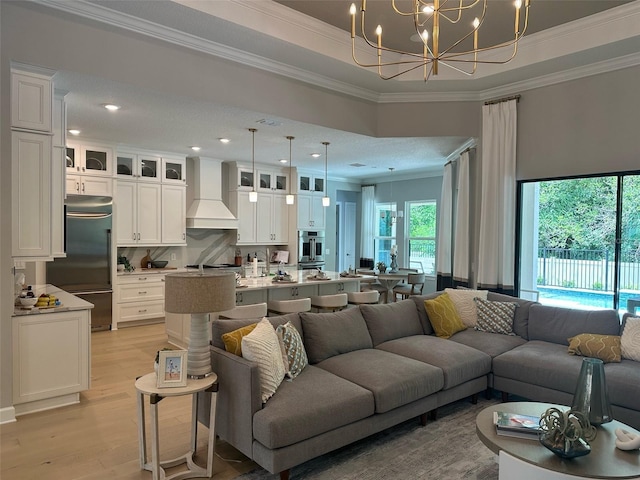 10193 Brocksport Cir, Gotha, FL 34734 - living area featuring ornamental molding, light wood-style flooring, a chandelier, and recessed lighting
