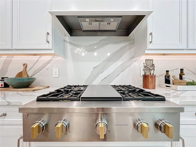 kitchen featuring white cabinetry and ventilation hood