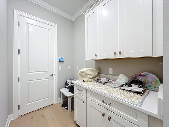 washroom with crown molding and light wood-type flooring