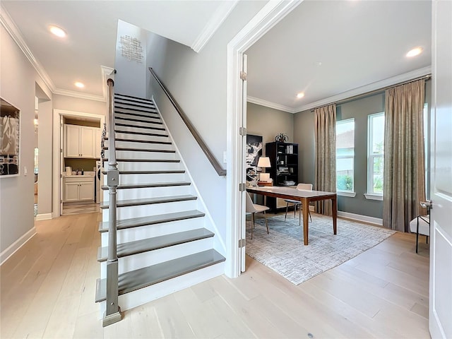 stairs featuring ornamental molding and wood-type flooring