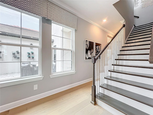 10193 Brocksport Cir, Gotha, FL 34734 - stairway featuring healthy amount of natural light, wood finished floors, crown molding, and recessed lighting