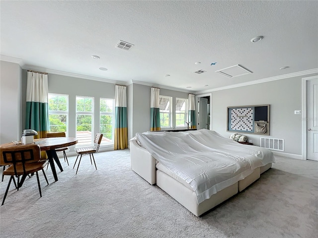 bedroom featuring ornamental molding, a textured ceiling, and light colored carpet