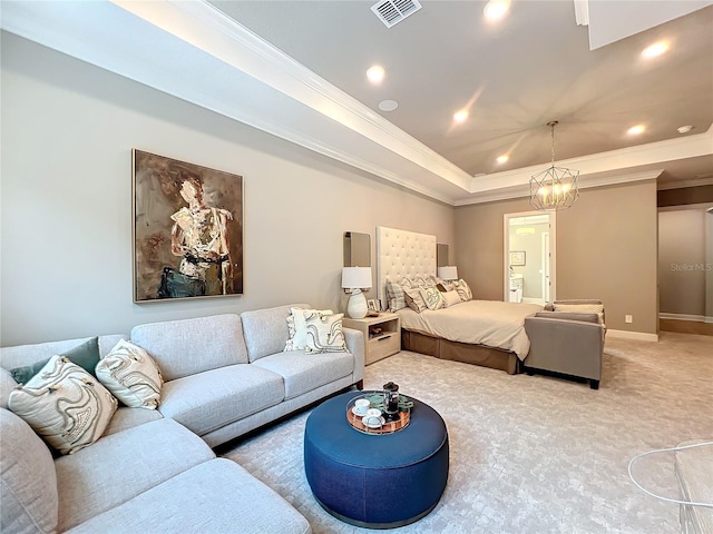 carpeted bedroom featuring ornamental molding, a tray ceiling, and a chandelier