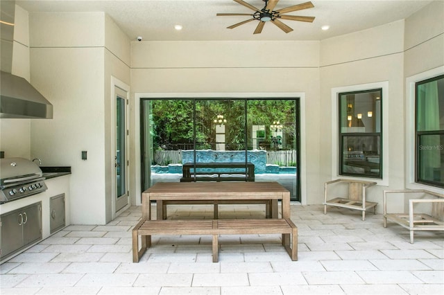 view of patio / terrace featuring ceiling fan, exterior kitchen, and a grill