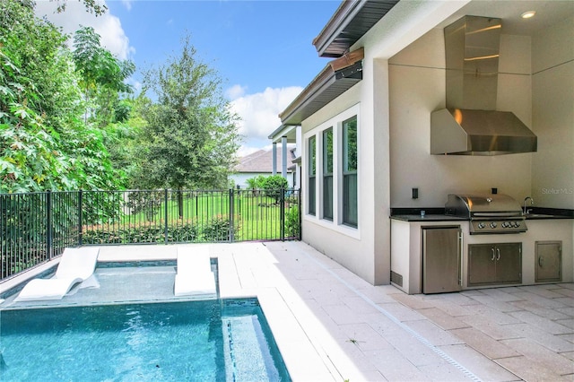 view of pool featuring a patio area, sink, an outdoor kitchen, and grilling area