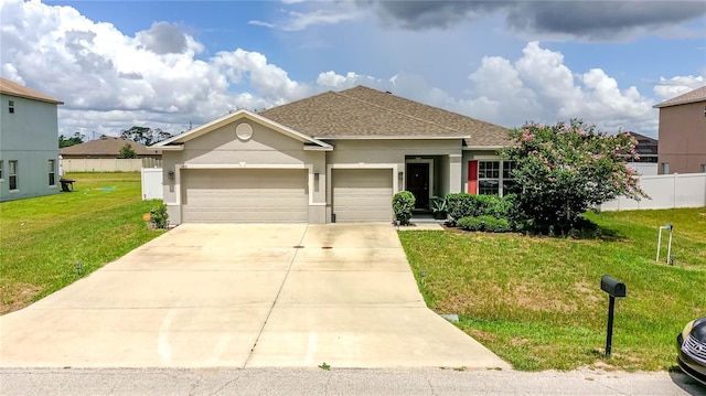 view of front of property with a garage and a front lawn