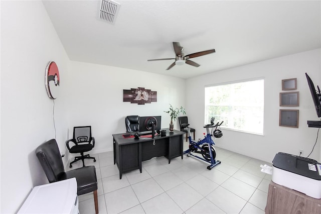 tiled home office featuring ceiling fan