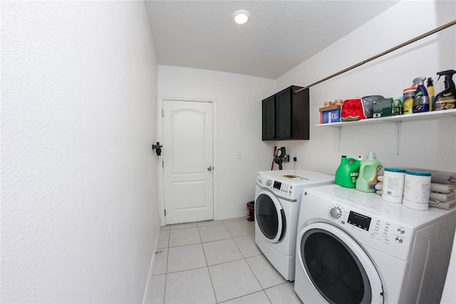 washroom with separate washer and dryer, cabinets, and light tile patterned flooring