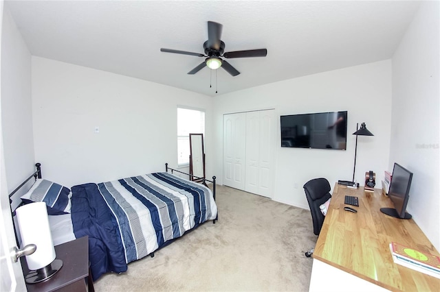 bedroom featuring ceiling fan, light colored carpet, and a closet