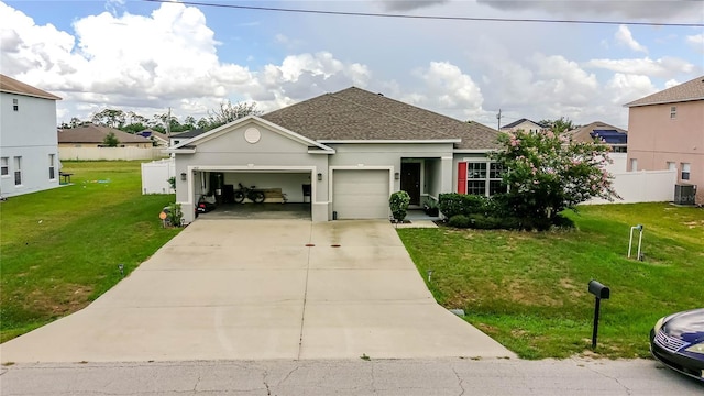 view of front of house with cooling unit, a garage, and a front yard