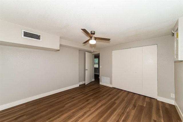 unfurnished bedroom featuring ceiling fan, a closet, and dark hardwood / wood-style flooring