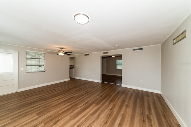 unfurnished living room featuring ceiling fan, crown molding, and dark hardwood / wood-style floors