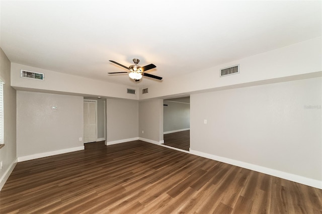 spare room featuring dark wood-type flooring and ceiling fan