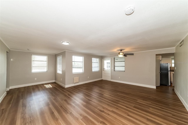 unfurnished living room with dark wood-type flooring, ceiling fan, and ornamental molding