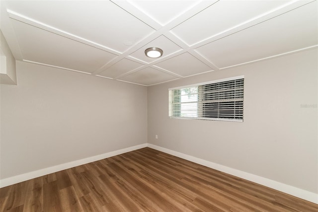 empty room featuring coffered ceiling and hardwood / wood-style floors