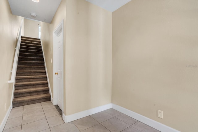 stairway featuring tile patterned flooring