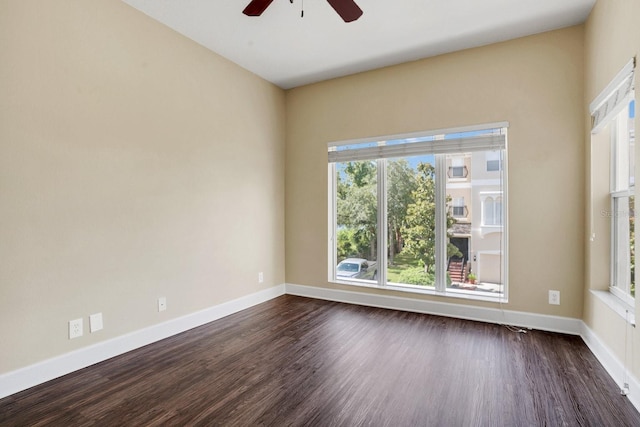 spare room with ceiling fan and dark hardwood / wood-style flooring