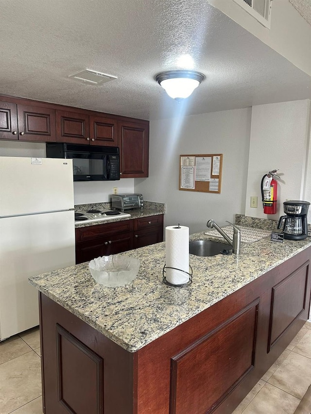 kitchen with light stone countertops, sink, a textured ceiling, and white appliances