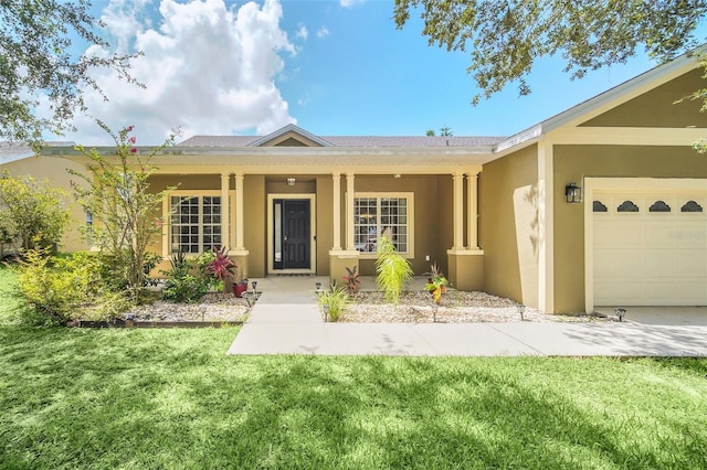 view of front of home with a garage and a front lawn