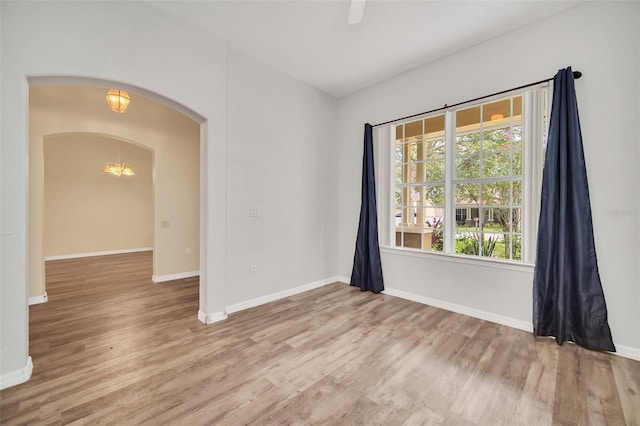 spare room with light hardwood / wood-style floors and ceiling fan