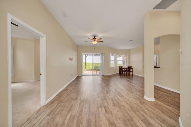 unfurnished living room featuring ceiling fan and light hardwood / wood-style flooring