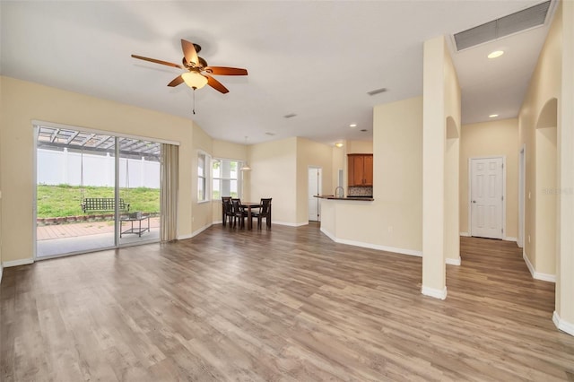 unfurnished living room featuring ceiling fan and light wood-type flooring