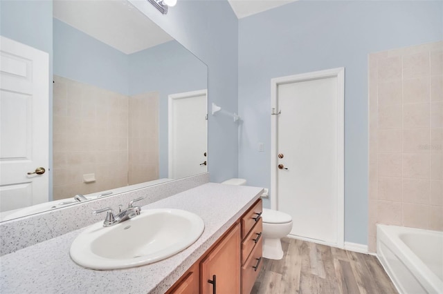 bathroom featuring hardwood / wood-style flooring, vanity, and toilet