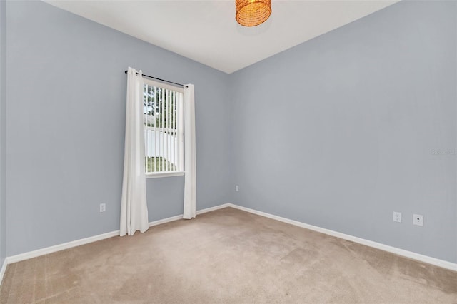 unfurnished room featuring light colored carpet