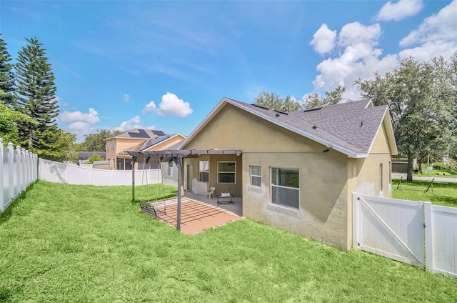 rear view of house with a yard, a patio area, and a pergola