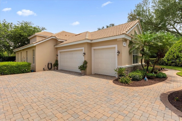 mediterranean / spanish home featuring a garage