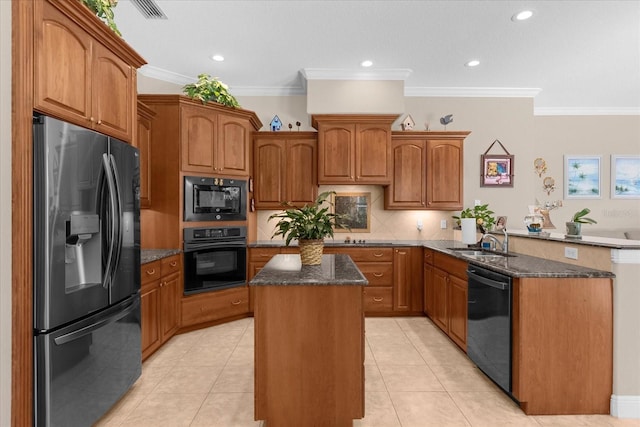 kitchen featuring sink, black appliances, a kitchen island, kitchen peninsula, and dark stone counters