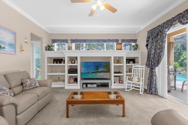 carpeted living room with ornamental molding and ceiling fan