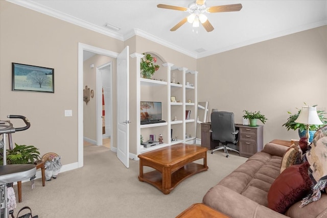 office space with crown molding, ceiling fan, light carpet, and ornate columns