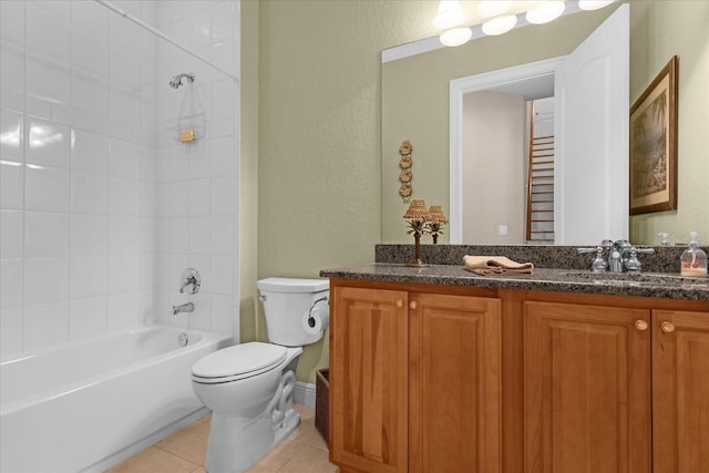 full bathroom with vanity, tiled shower / bath, tile patterned floors, and toilet