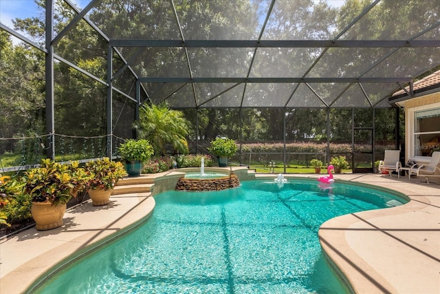 view of swimming pool with an in ground hot tub, a patio area, and glass enclosure