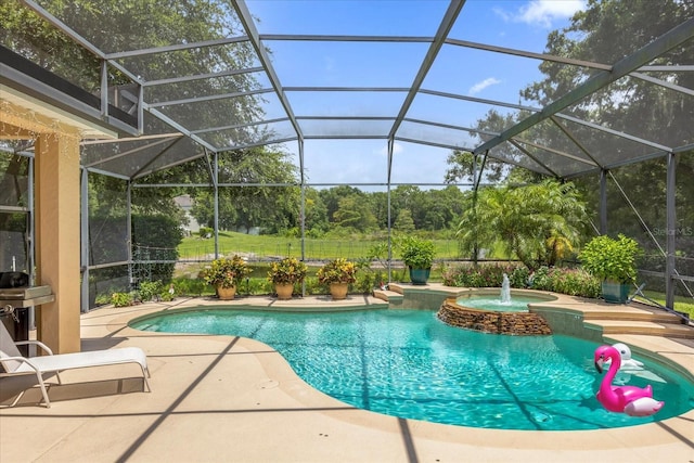 view of pool with a patio area, an in ground hot tub, pool water feature, and glass enclosure