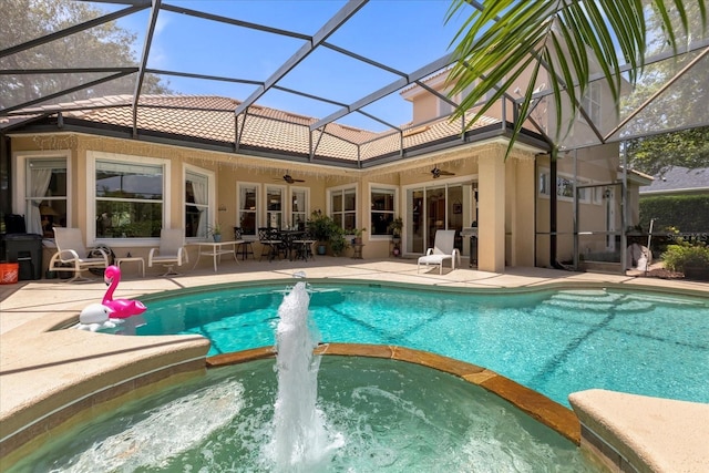 view of pool with a patio, a lanai, and ceiling fan