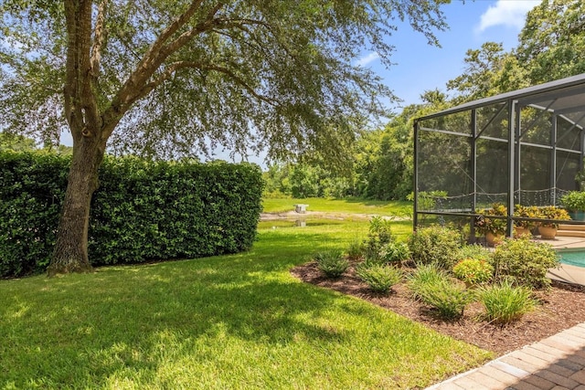 view of yard featuring glass enclosure