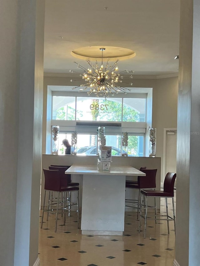 interior space featuring an inviting chandelier, crown molding, hanging light fixtures, and light tile patterned floors