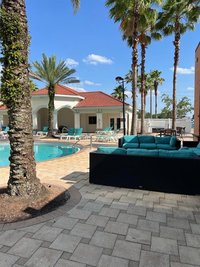 view of swimming pool featuring an outdoor living space and a patio area