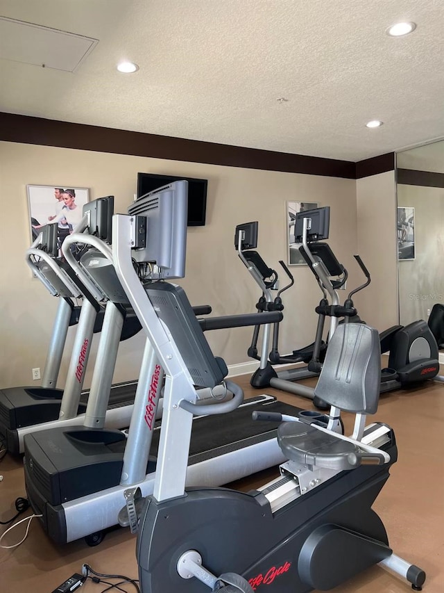 gym featuring a textured ceiling